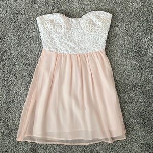 strapless white lacy corset mini dress with light pink flowy bottom